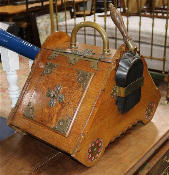 A Victorian Gothic revival oak and brass mounted coal box and shovel W.13in.